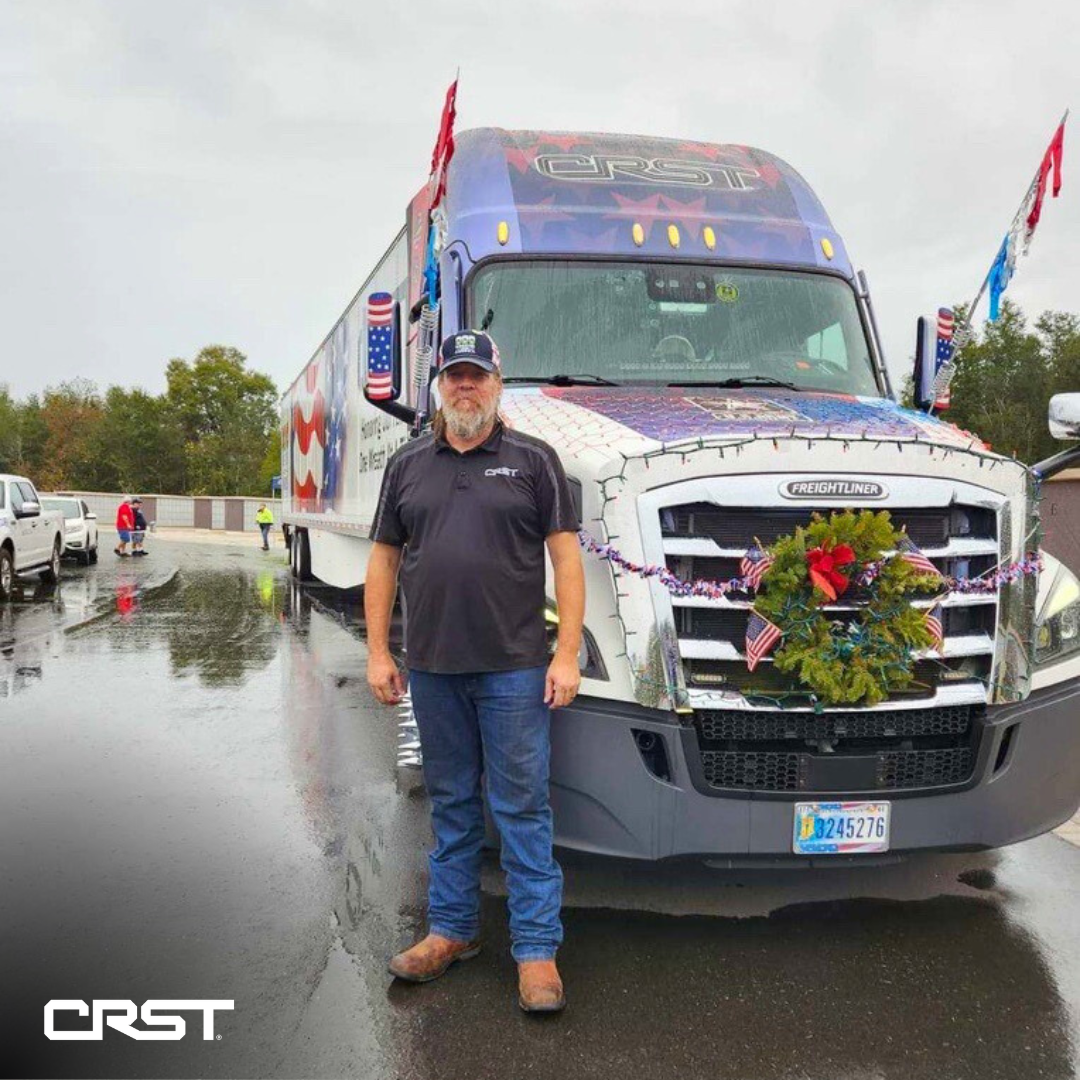 Jim Nalin stangding in front of his truck with a wreath on the front.