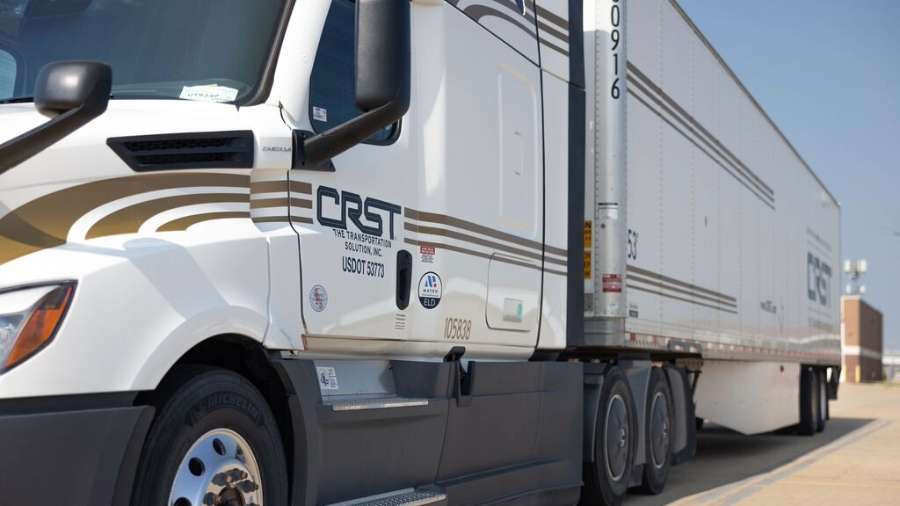 A CRST semi-truck parked under clear skies, representing Greg Bowman's journey as a new freight agent with CRST.