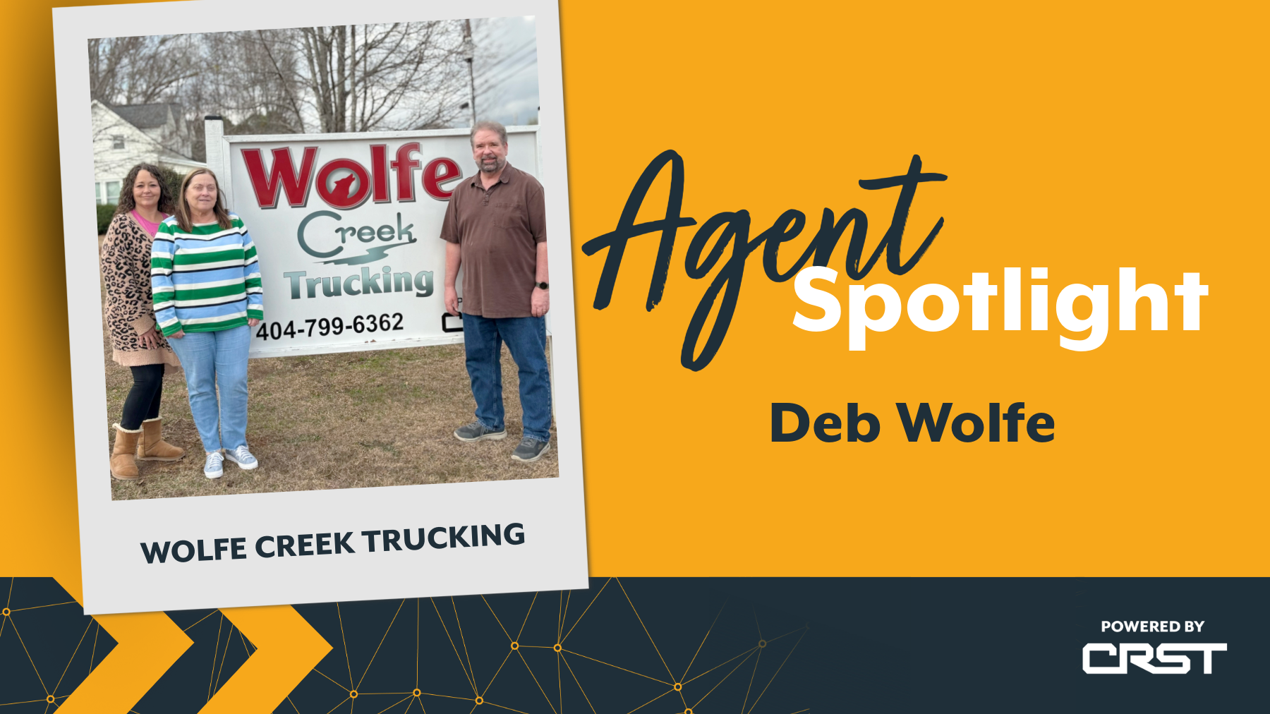 Deb Wolfe and her team from Wolfe Creek Trucking stand in front of their company sign, representing their strong relationships and commitment to delivering results as part of the CRST agent network.